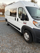 White Ram ProMaster camper van for RV rental, showcasing its side profile, windows, and practical step.