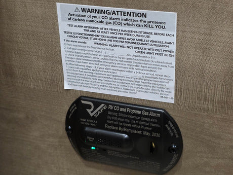 RV rental: CO and Propane Gas Alarm with crucial safety warnings and emergency instructions for gas detection.