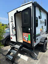 Rugged NoBo travel trailer with open door & extended steps, perfect for your next RV rental adventure.