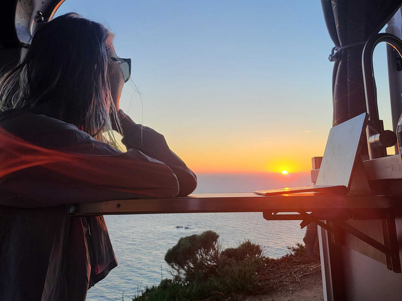 Person watches a vibrant ocean sunset from their RV rental. Perfect mobile office for travel & remote work. — photo 19