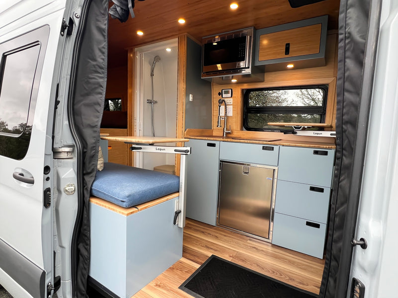 bamboo accents. Shower and toilet visible on left.|Well-equipped rv rental kitchen with a stainless steel sink — photo 14