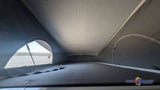 Inside an rv rental camper van, showcasing the pop-top sleeping area with a bed and an open canvas window for bright views and camping.