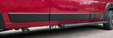 Side view of a red RV rental, showcasing its black lower body cladding, side step, and external hookups including a hose carrier.