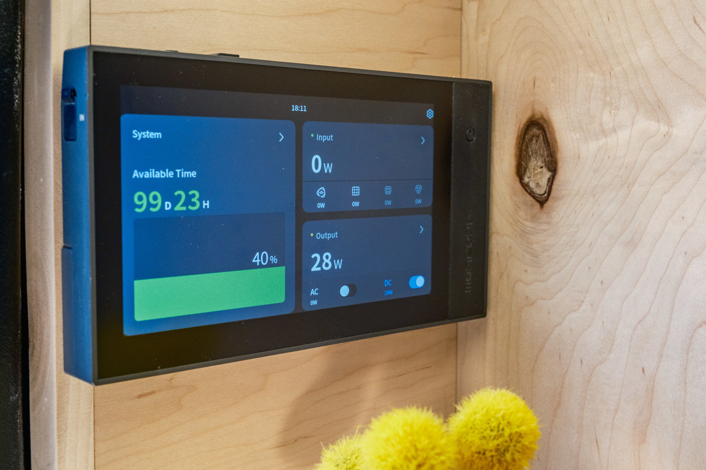 An EcoFlow power display mounted on wood in an rv rental, showing 40% battery, 99 days runtime, and 28W DC output.