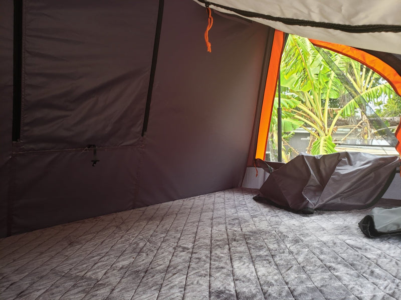  offers an rv rental alternative.|Cozy RV rental bed with a view of the beach and ocean. Perfect for scenic camping trips.|RV rental kitchen kit: A clear bin filled with camping cookware — photo 2