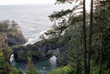 Explore stunning coastal scenery via RV rental: natural rock arch, cliffs, & forests meet the Pacific Ocean.