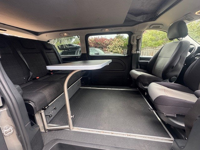 Inside this versatile rv rental campervan: a pull-out table, adaptable seating, and durable flooring for your road trip comfort. — photo 5