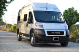 A white Winnebago Ram ProMaster camper van, perfect for your next rv rental adventure, parked on a gravel path.