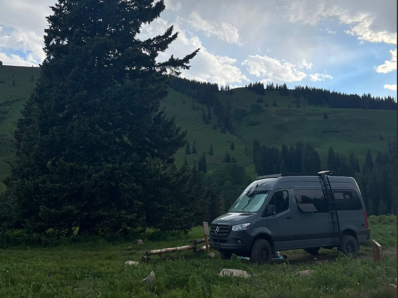  and a window overlooking a forest.|Cozy RV rental interior with a comfortable bed — photo 12