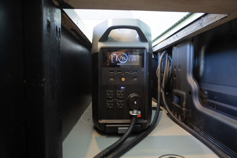 An EcoFlow portable power station, showing 74% charge & 129W output, powers devices in an rv rental. — photo 17
