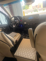 Luxurious Mercedes-Benz Sprinter RV rental interior: featuring plush quilted seats and a modern, high-tech dashboard.