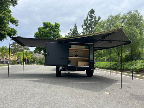 Explore with this RV rental! Off-road trailer with rear kitchen, open storage, and extended awnings for shaded outdoor living.