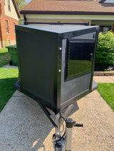 Rugged black utility trailer with diamond plate, ideal for gear on your next RV rental journey. Includes a side door.