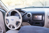 Ford SUV rv rental interior: dashboard view with steering wheel, aftermarket Pioneer stereo, and climate controls.