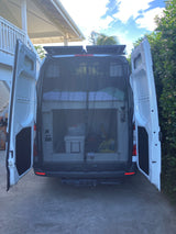 Rear view of an RV rental camper van with open doors, revealing custom bunk beds, mosquito net, and ample storage inside.