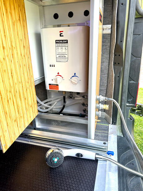RV rental featuring an Eccotemp portable water heater and outdoor shower setup, ideal for mobile adventures.