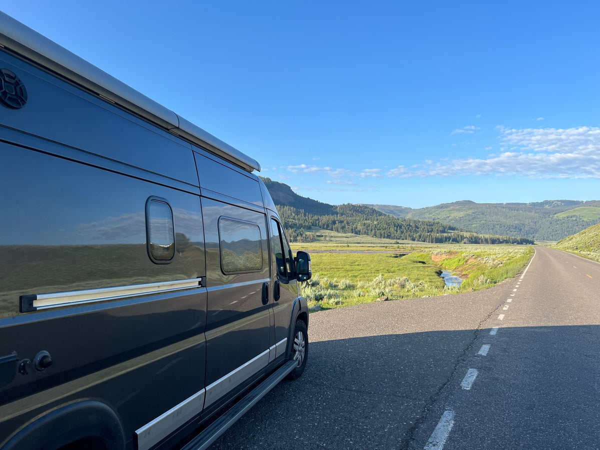  parked in a vast landscape.|RV rental adventure: a dark camper van parked on a vast — photo 7