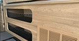 RV rental interior with light wood-grain cabinetry, two mesh storage pockets, and a beige air vent.