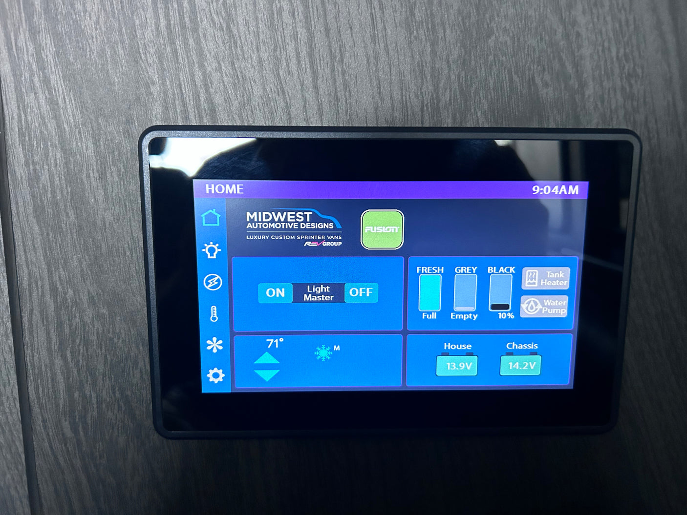 This RV rental's smart control panel displays tank levels (fresh, grey, black), 71° temperature, battery voltage, & system settings.