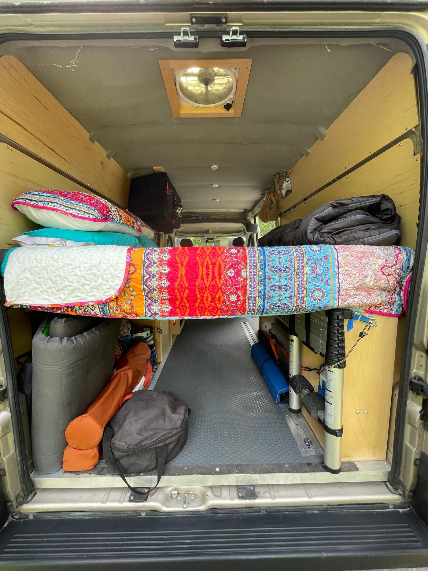  and warm wood paneling.|Interior of a comfortable **rv rental** van with passenger and front seats — photo 7