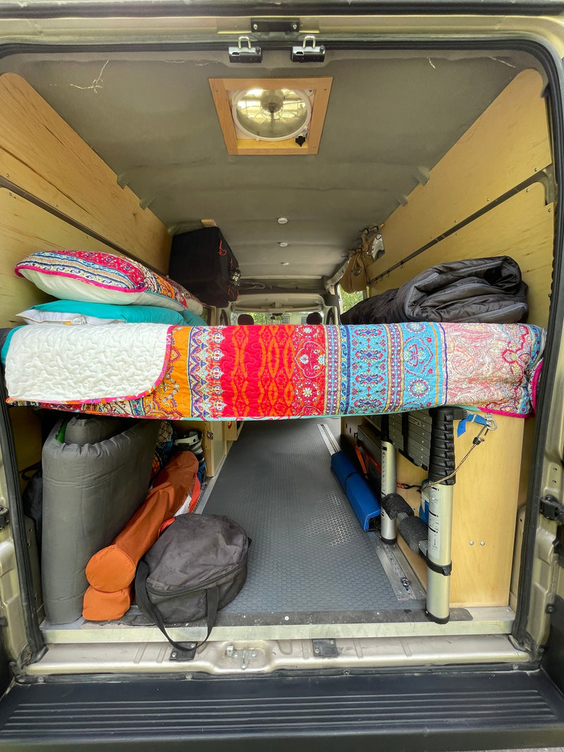  and warm wood paneling.|Interior of a comfortable **rv rental** van with passenger and front seats — photo 7