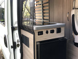 RV rental camper van interior showing kitchenette with stove, fridge, and slatted bed frame. Ready for adventure.