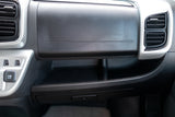 Passenger dashboard of an RV rental, featuring air vents, an 'AIR bag' glove box, and convenient multi-level storage with power outlets.