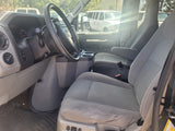 Inside an rv rental van: driver's perspective with steering wheel, dashboard, and front passenger seats visible.