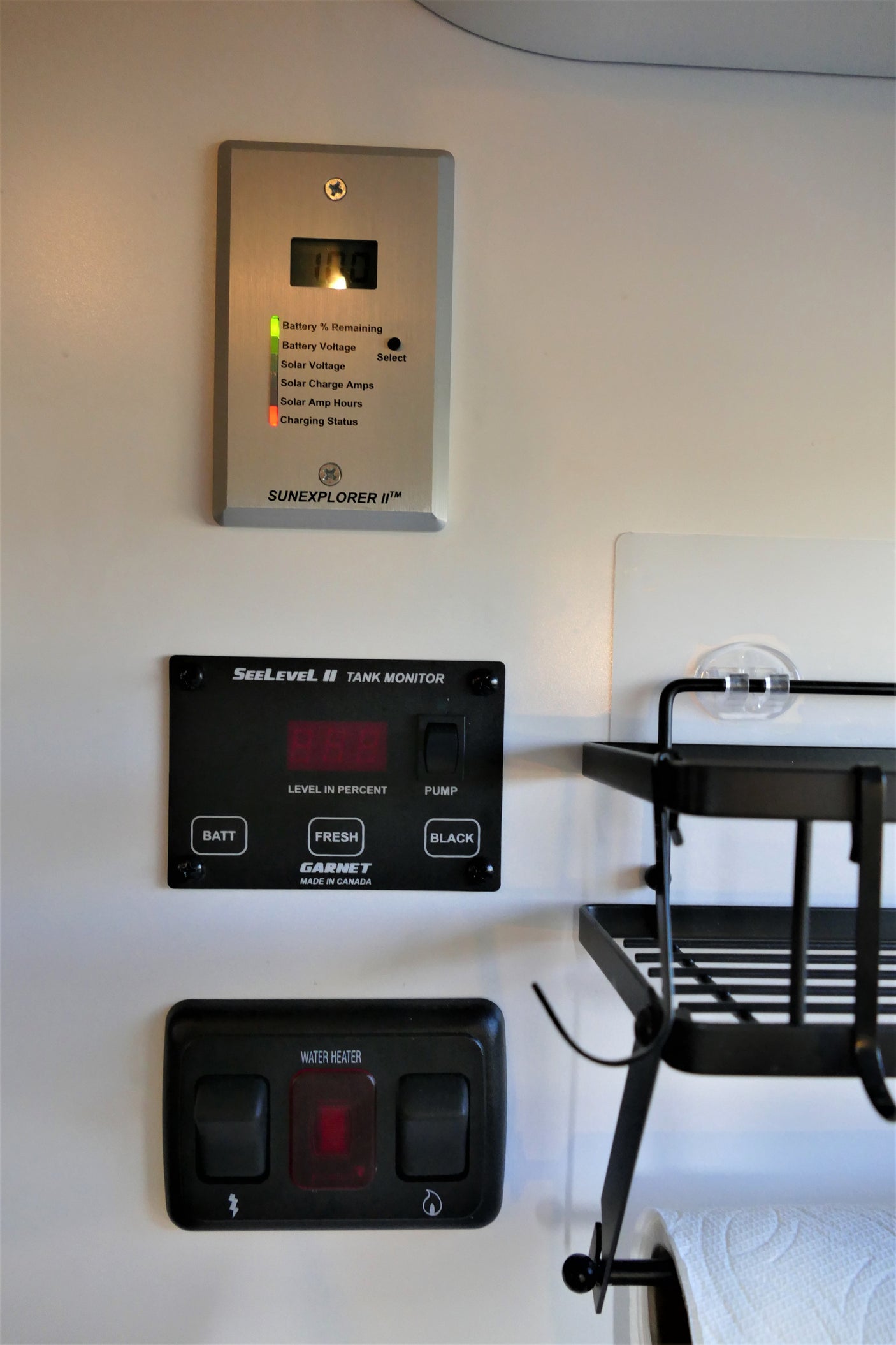 RV rental dashboard: Battery at 100% on SunExplorer, SeeLevel tank monitor, and water heater controls ready for use.