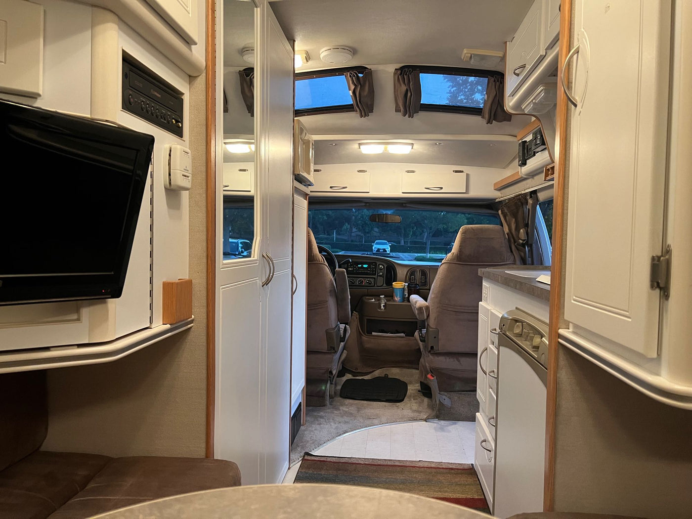  parked by trees.|Spacious rv rental interior — photo 8