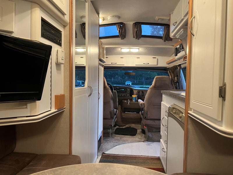  parked by trees.|Spacious rv rental interior — photo 8