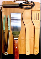 Essential kitchen tools like tongs, spatulas, and whisk, neatly arranged on a bamboo board, perfect for your next RV rental adventure.