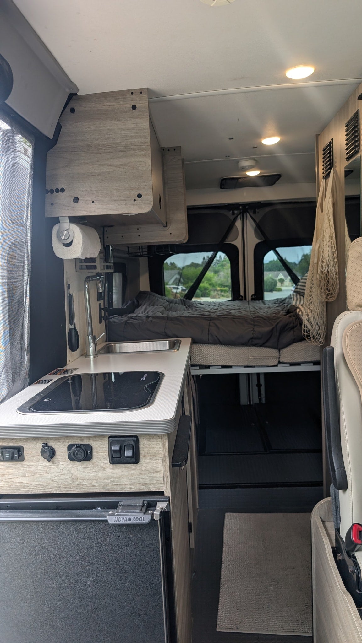  star-filled night sky with distant mountains silhouetted.|White camper van (rv rental) parked on a sunlit road — photo 9