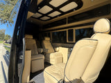 Plush beige seating and custom lighting define this luxurious RV rental's interior, offering ultimate comfort for your travels.
