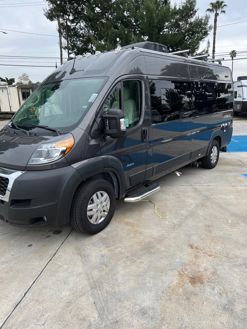 This dark gray Jayco Swift camper van rv rental, with roof racks and step bars, is parked on concrete. — photo 1