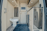 Explore this RV rental's cozy interior, featuring a built-in toilet, compact kitchen, and smart storage solutions.