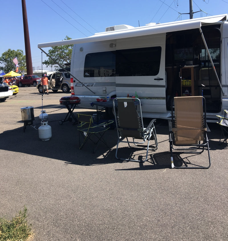 RV rental setup for a tailgate event with grill, chairs, and cooking gear. Perfect for outdoor leisure. — photo 9