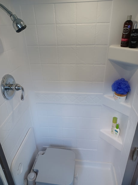 Compact shower and toilet setup in an RV rental, stocked with toiletries. Ideal for your next road trip adventure!