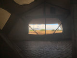  a potential rv rental for outdoor adventures.|White Toyota Tacoma truck with covered rooftop tent