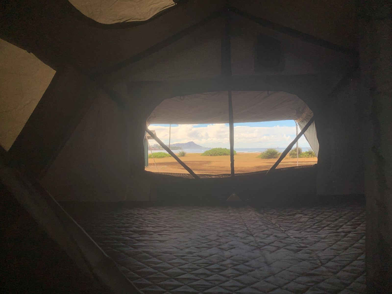  a potential rv rental for outdoor adventures.|White Toyota Tacoma truck with covered rooftop tent