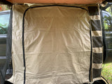 Spacious RV rental annex for camping, featuring zip-up entry, storage pockets, and mesh screens for comfortable outdoor shelter.