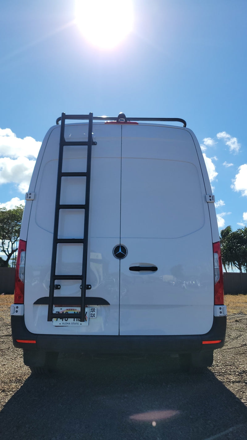  and counter. Kitchen with black sink/stove. Front seats face a desert view.|White Mercedes-Benz Sprinter camper van — photo 11
