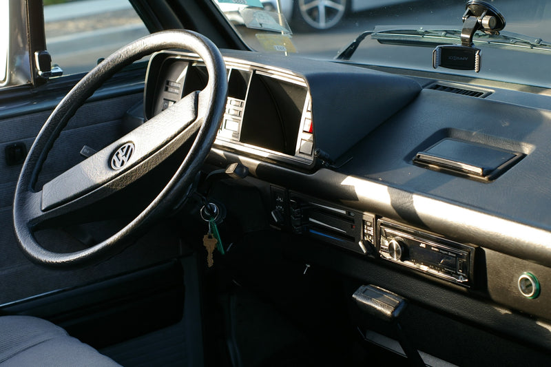 Inside a classic VW camper van, perfect for your RV rental, featuring the steering wheel, dashboard, and radio. — photo 2