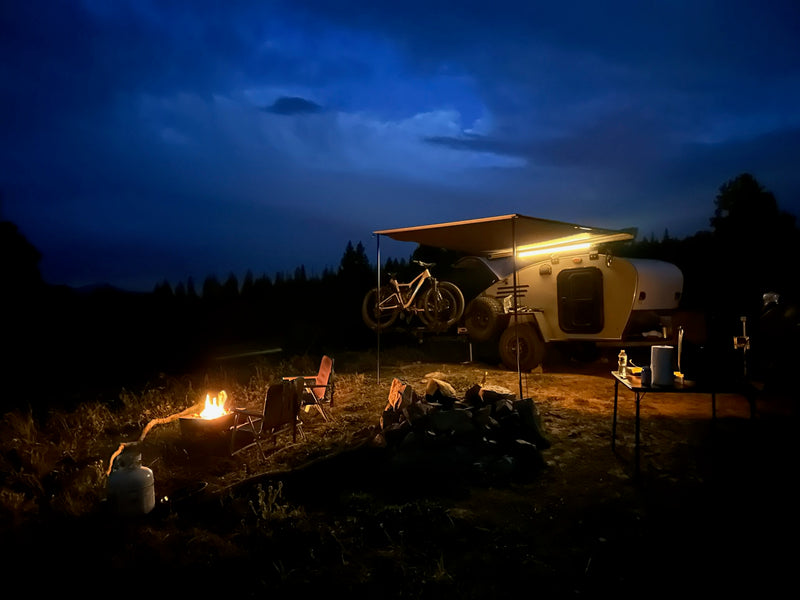  parked with snowy mountains.|Scenic RV rental campsite: A teardrop trailer with bikes — photo 3