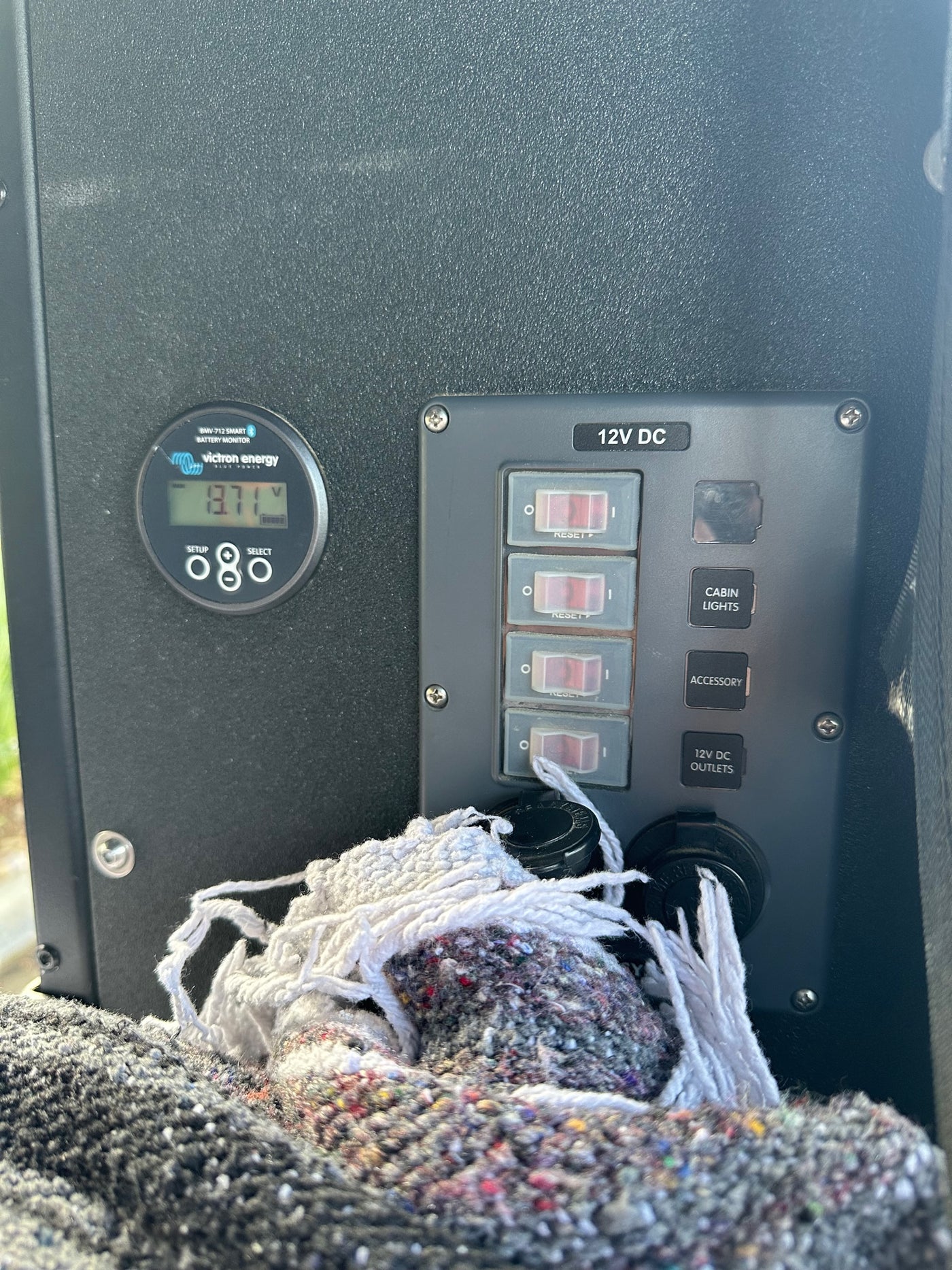 RV rental control panel: 12V DC switches for cabin lights & accessories, 12V outlets, and Victron battery monitor at 13.71V. — photo 20
