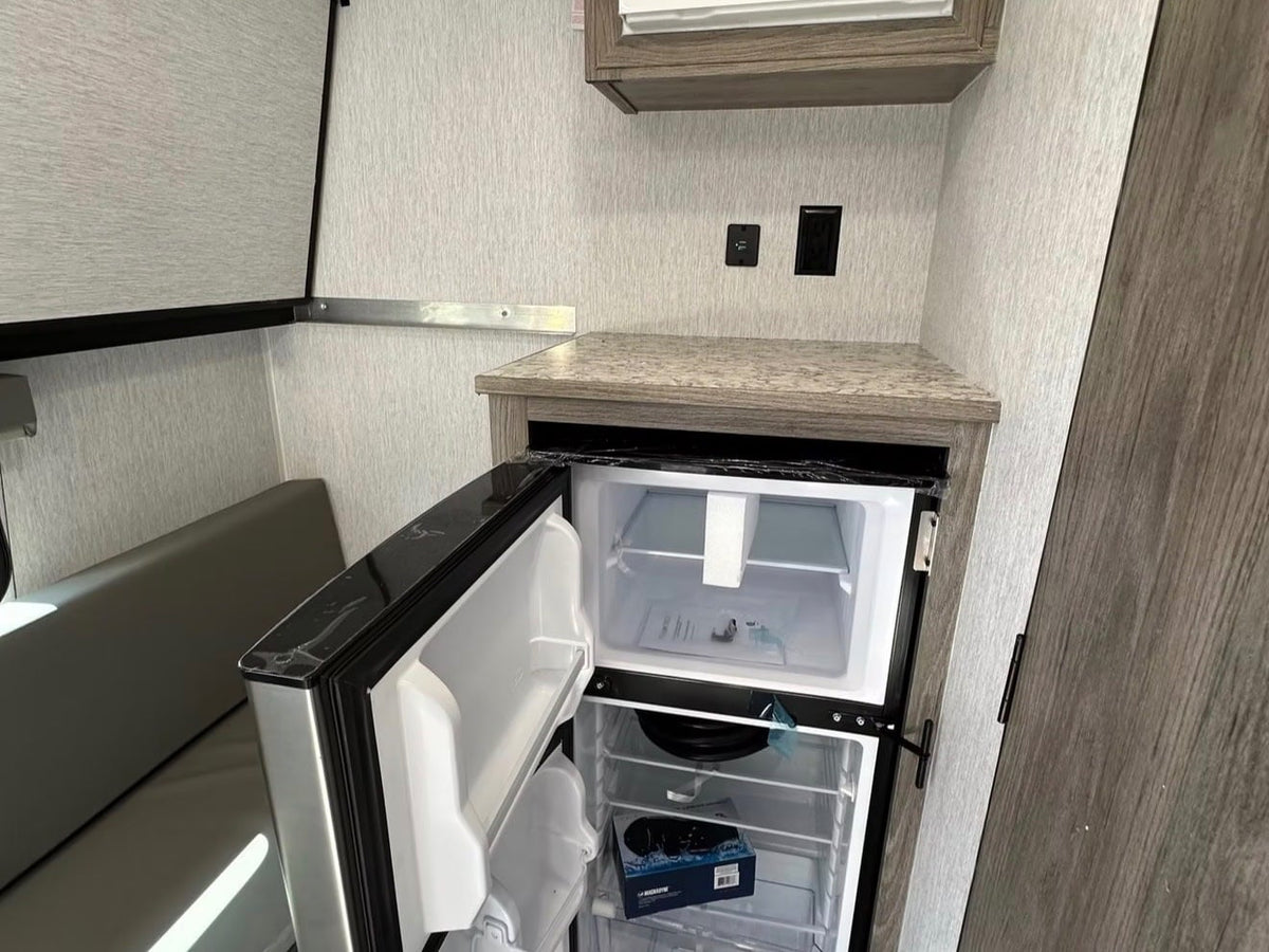  kitchen corner & storage. Ideal for camping adventures.|RV rental interior: Raised bunk bed — photo 7