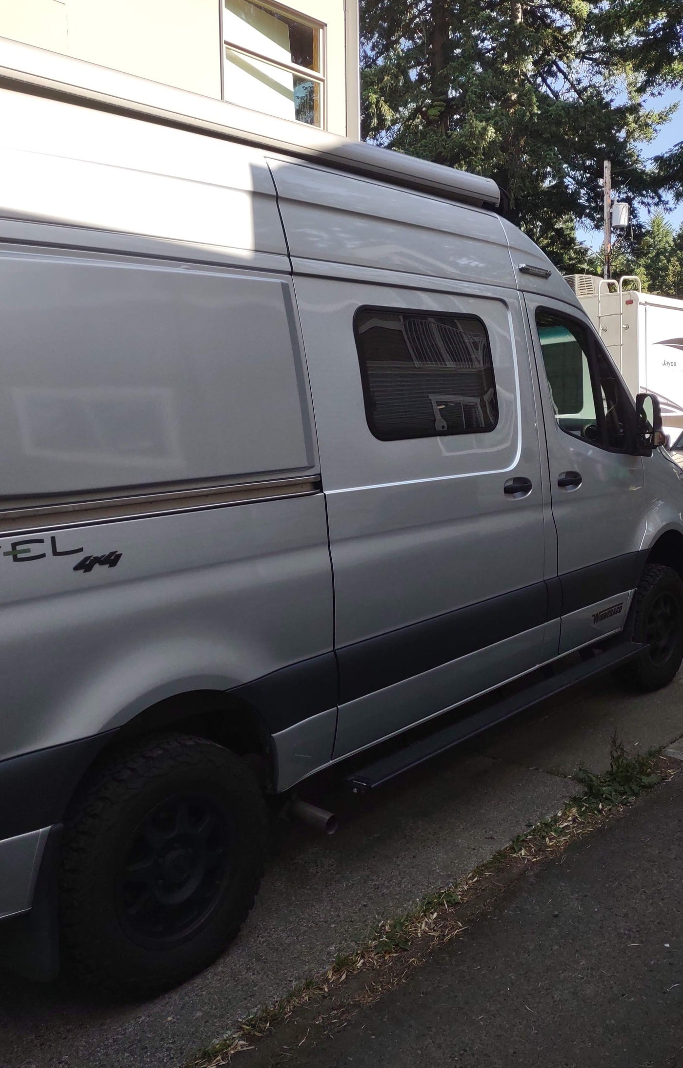 Silver Winnebago Revel 4x4 camper van, perfect for your next rv rental trip. Features awning & all-terrain tires. — photo 9