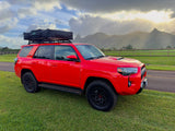 Bright red Toyota 4Runner with rooftop tent, ideal for overland adventures or as an RV rental alternative in the mountains.