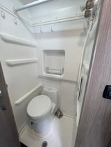 Compact RV rental wet bath with integrated toilet and shower, optimized for small spaces and travel.