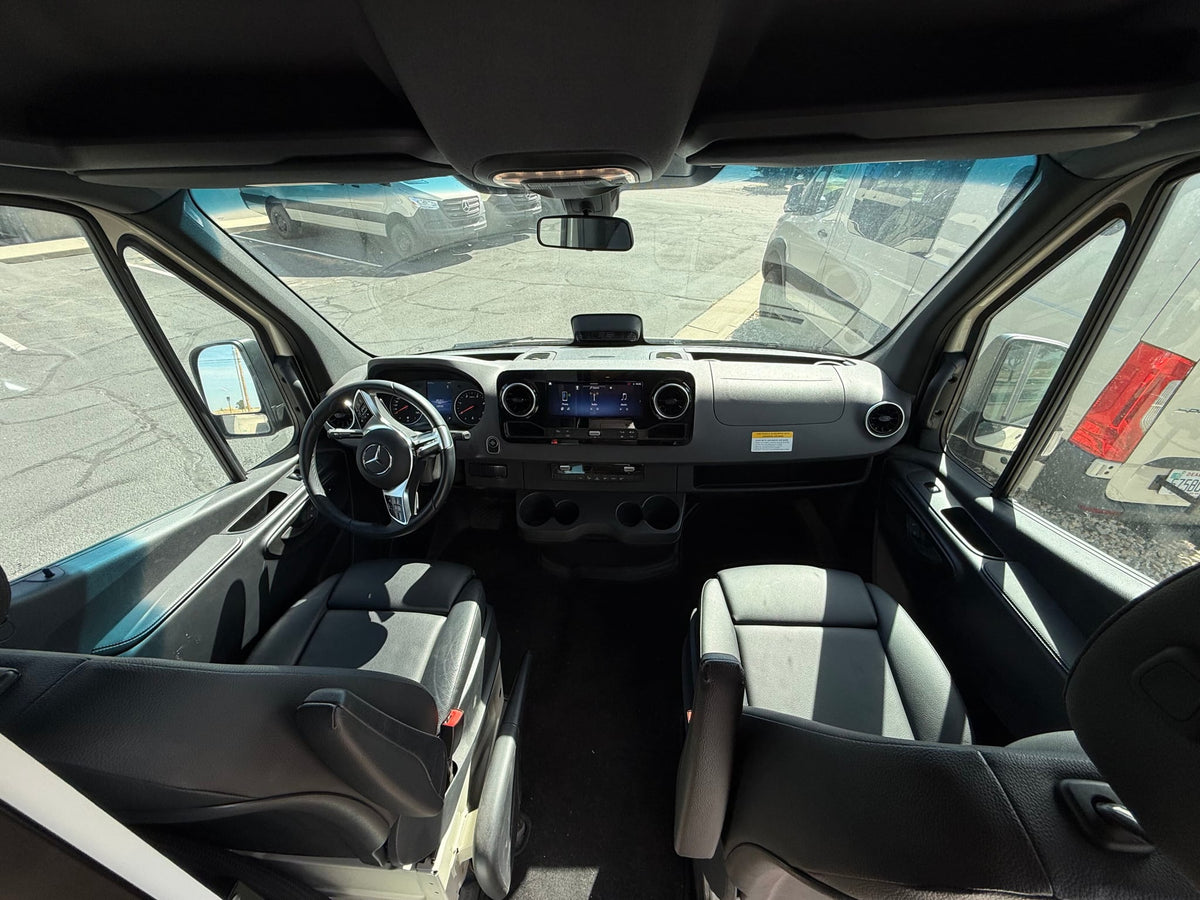  parked on gravel. Ideal for adventure.|Rear view of this rv rental van shows its custom VANCRAFT interior through open doors: bed — photo 5